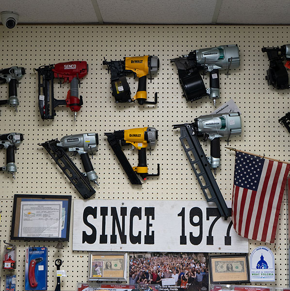 a wall with various hardware tools hanging